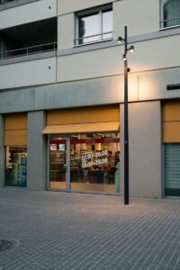 a street light sitting next to a tall building